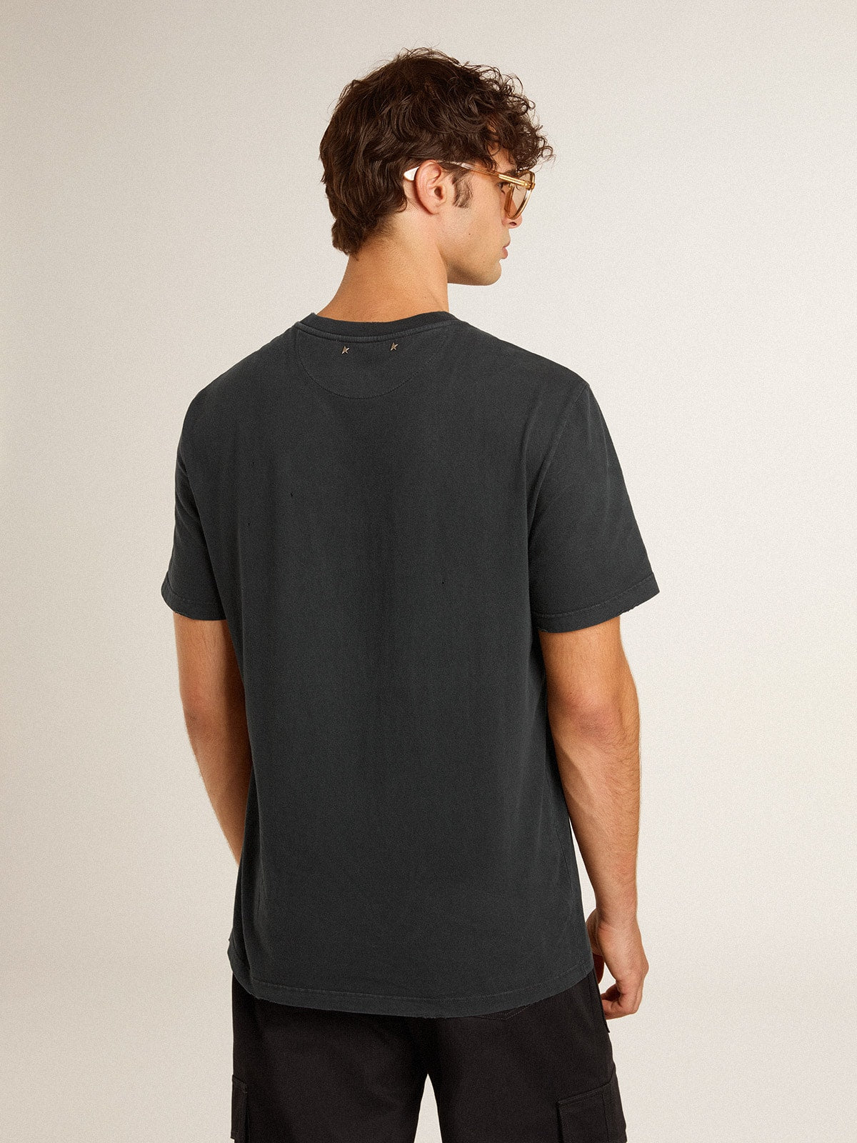 Men’s worn-black cotton T-shirt with print on the front