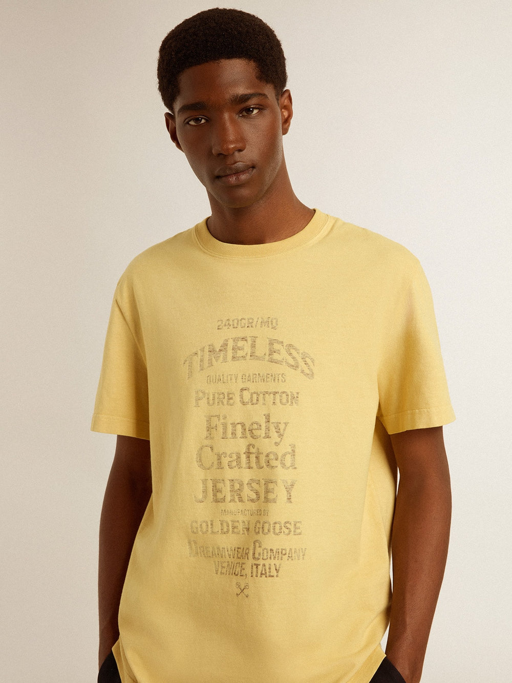 Men's cotton T-shirt in pale yellow with faded lettering
