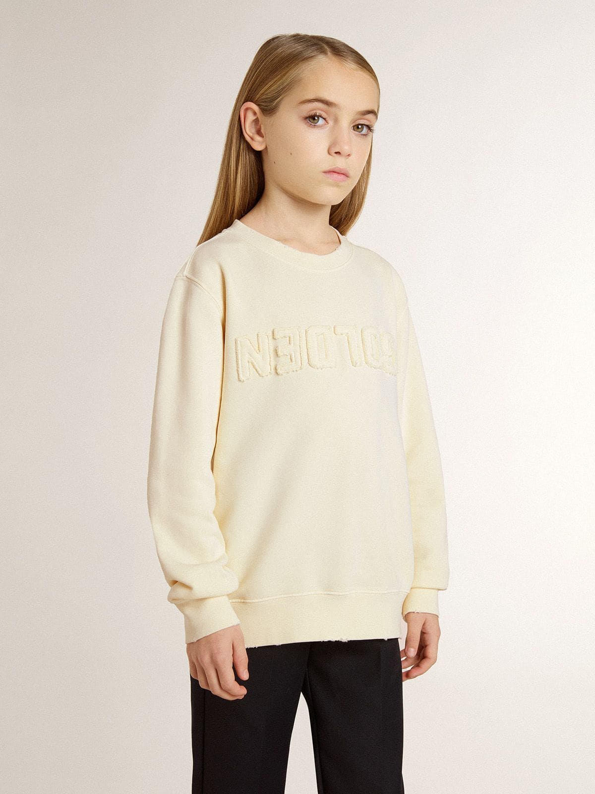 Girls’ cream-colored sweatshirt with patch writing