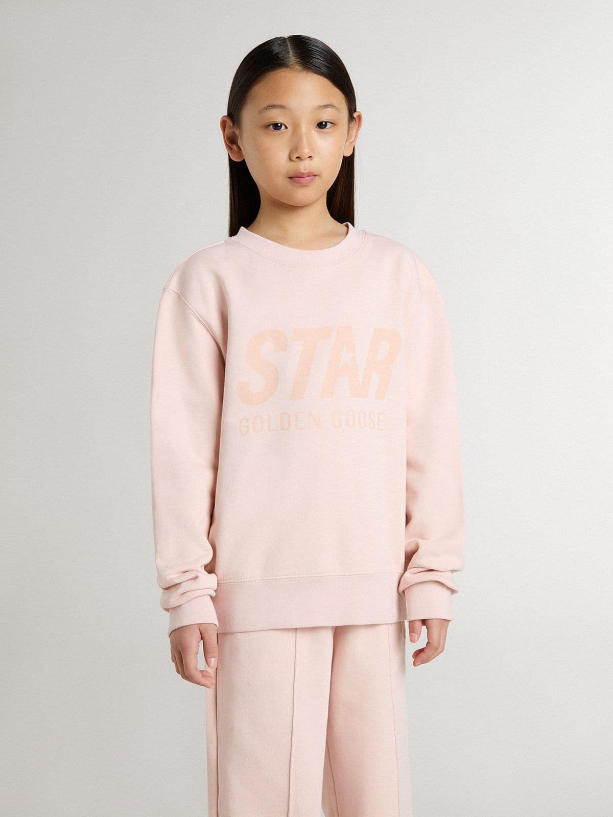 Girls' pink-colored sweatshirt with pink front lettering