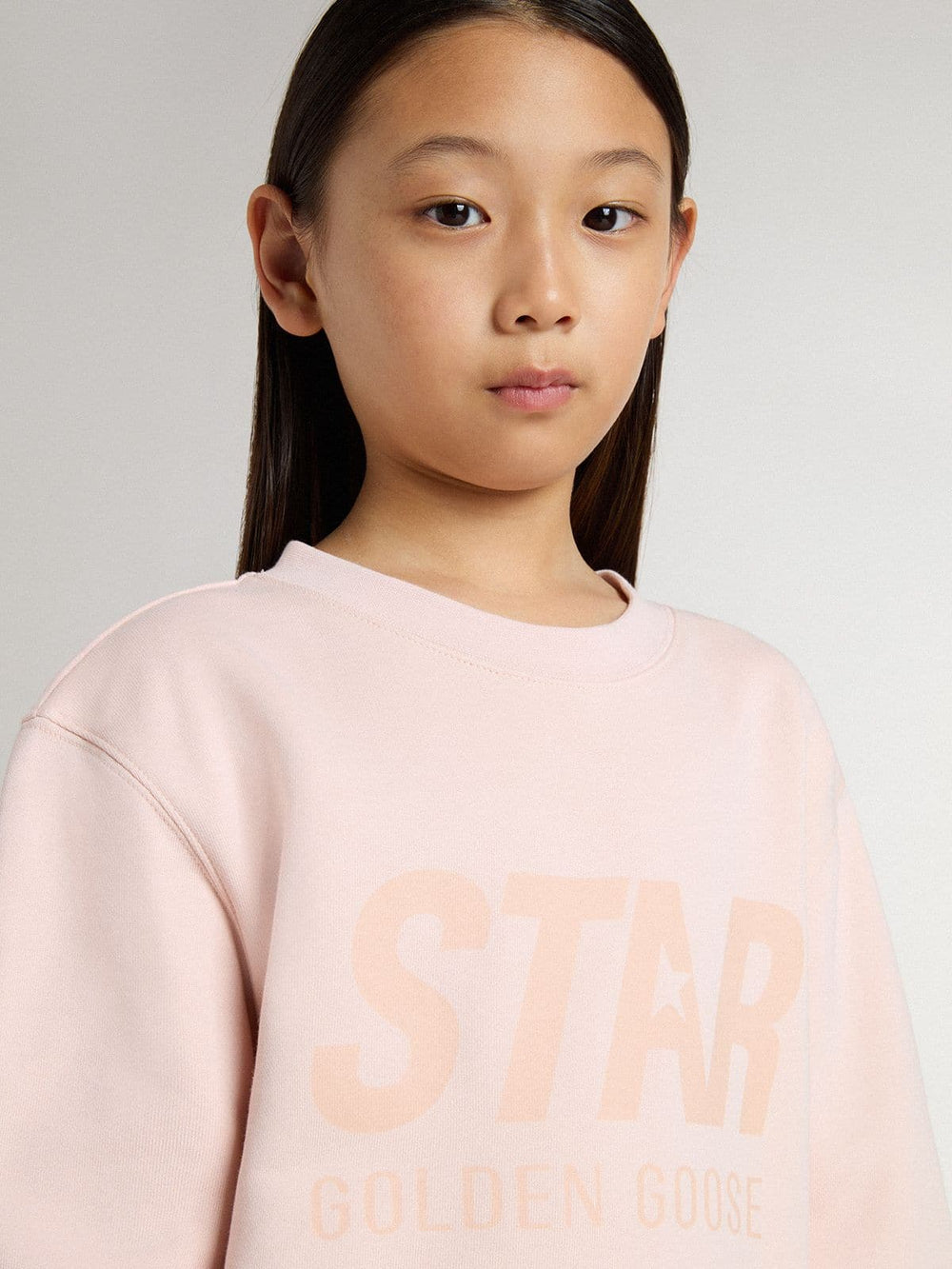 Girls' pink-colored sweatshirt with pink front lettering