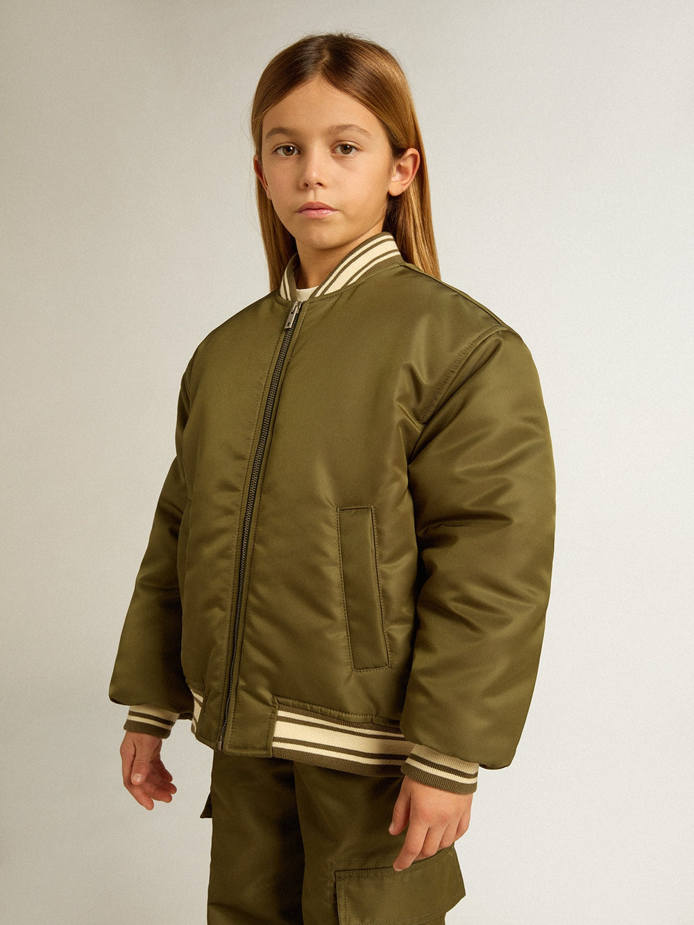 Kids military-green nylon bomber jacket with lettering on the back
