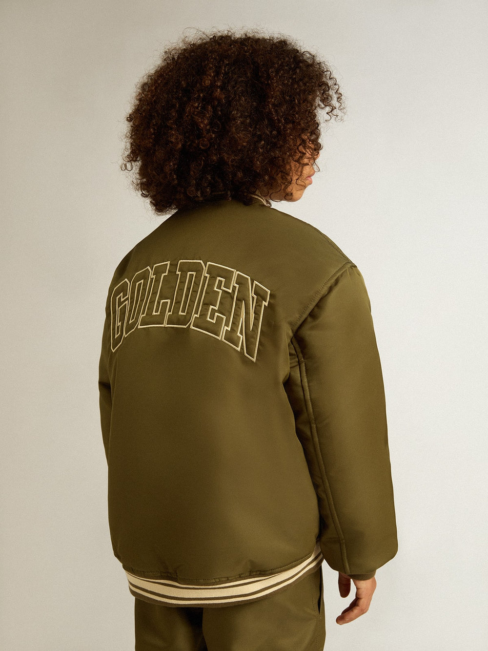 Kids military-green nylon bomber jacket with lettering on the back