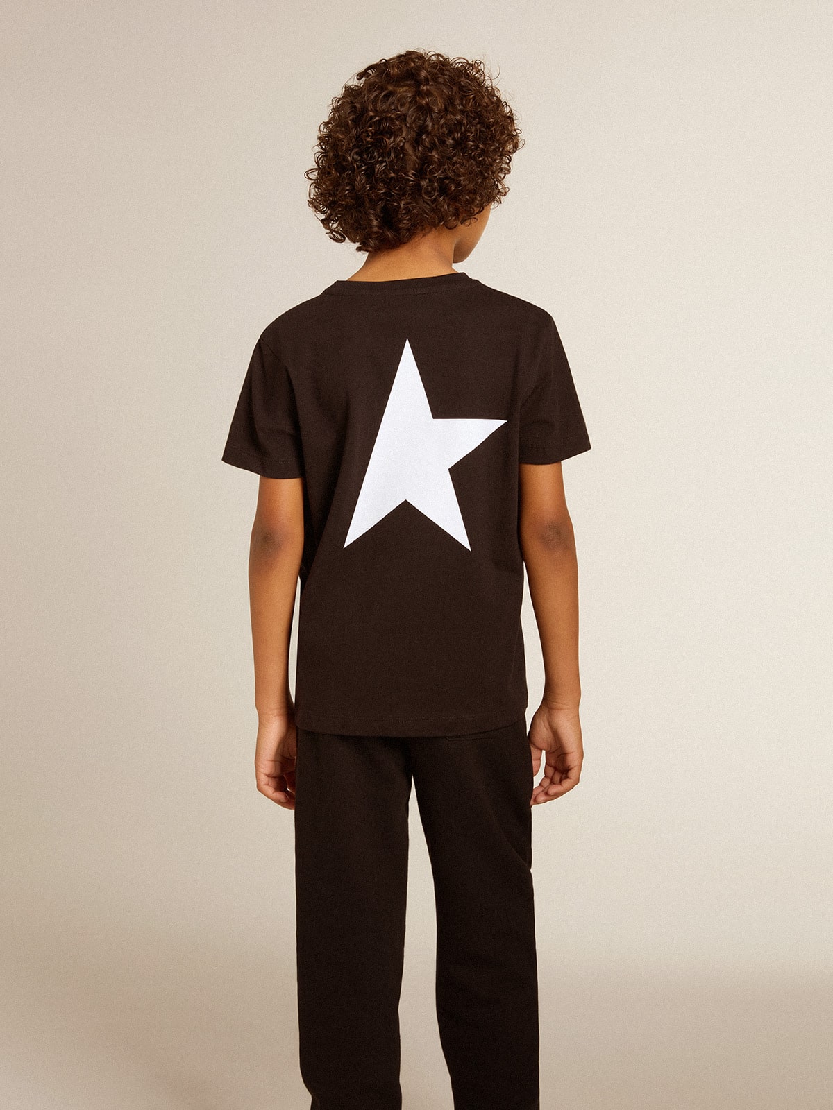 Black T-shirt with contrasting white logo on the front and maxi star on the back