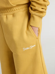 Kids jogging shorts in ochre yellow with embroidery