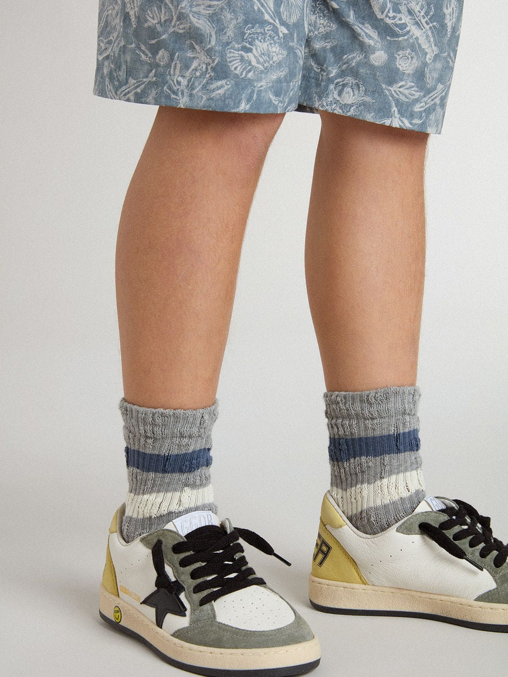 Kids’ gray socks with distressed details and worn-white and blue stripes
