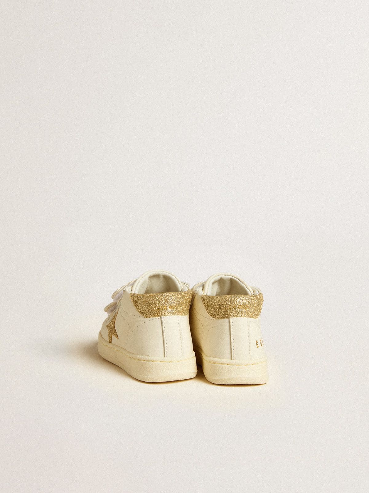 June Junior in white nappa leather with gold glitter star and heel tab