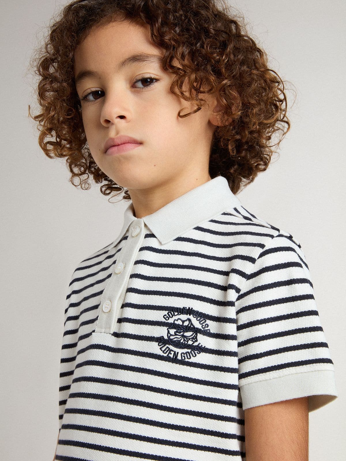 Boys' white cotton polo with navy blue stripes and embroidery