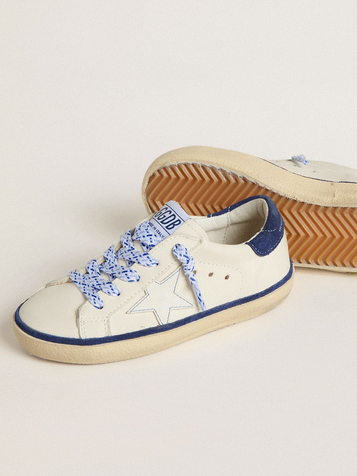 Junior Super-Star in white leather with blue suede heel tab